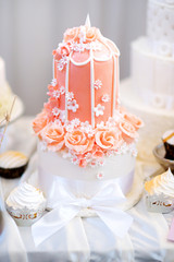 Pink wedding cake decorated with sugar flowers