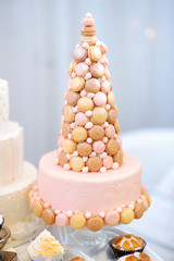 Pink wedding cake decorated with macaroons