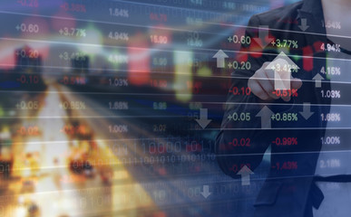 Double exposure of business woman and stock market graph