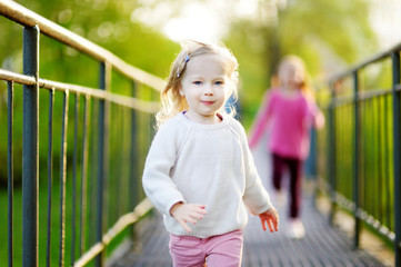 Two funny little girls running with joy and happines © MNStudio
