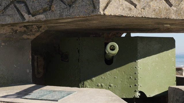 WW2 German canon hidden in bunker on beaches in northern France Normandy 4K 3840X2160 30fps UltraHD footage - World War 2 canon inside German bunker French beach 4K 2160p UHD video 