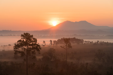 Sunrise above the mountain and misty forest on the morning.
