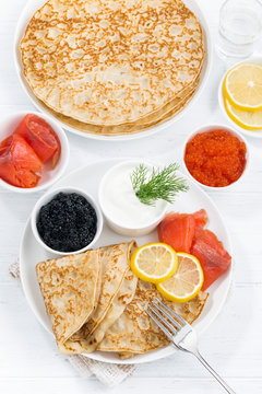 crepes with fish, sour cream and caviar, top view