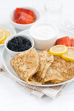 crepes with fish, sour cream and caviar, vertical