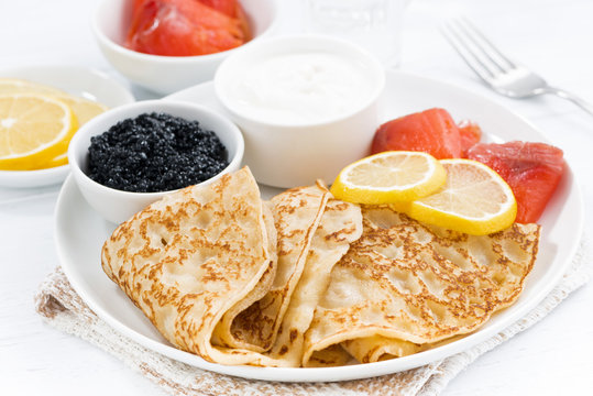 crepes with fish, sour cream and caviar