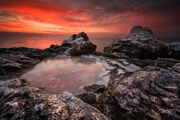 Fire and ice.
Rocky beach long exposure winter seascape at sunrise, Bulgaria.