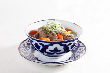 meat stew with vegetables peppers tomatoes Uzbek dish bowl  plate isolated white background