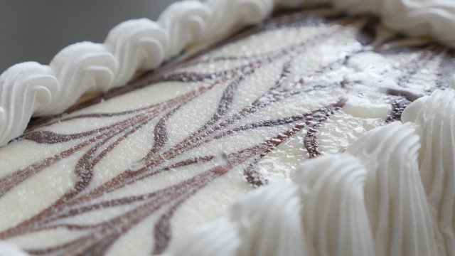 Decorated whipped cream vanila cake on table slow tilting over 4K 3840X2160 UHD video - Vanila and chocolate cake tasty after meal  dessert 4K 2160p UltraHD footage