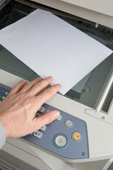 Businessman working with a printer in the office