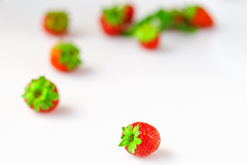 Macro strawberries close up in a white bowl.