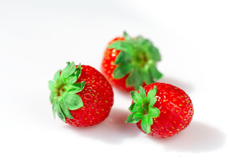 Macro strawberries close up in a white bowl.