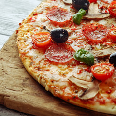 Delicious fresh pizza with mushrooms, cherry and pepperoni serve