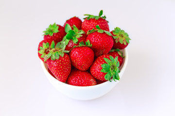 Isolated on white juicy red strawberries.