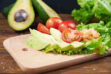 Vegetables and shrimps on a wooden background