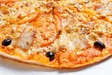 Freshly baked sliced pizza with olives