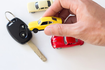 hand hold a car toy , car loan and car leasing concept.