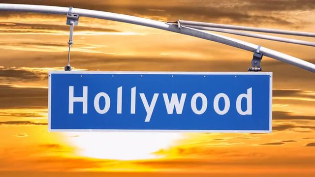 Hollywood Blvd street sign with time lapse sunset clouds.