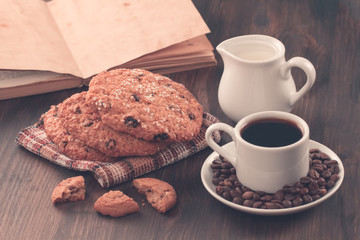 Chocolate chip cookies on an old vintage turquoise wooden background. Set table for breakfast. Hot Cup of coffee
