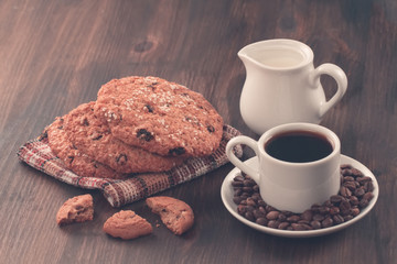 Chocolate chip cookies on an old vintage turquoise wooden background. Set table for breakfast. Hot Cup of coffee