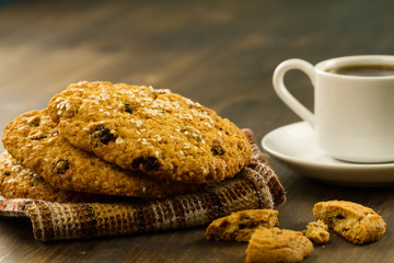 Chocolate chip cookies on an old vintage turquoise wooden background. Set table for breakfast. Hot Cup of coffee