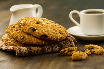 Chocolate chip cookies on an old vintage turquoise wooden background. Set table for breakfast. Hot Cup of coffee
