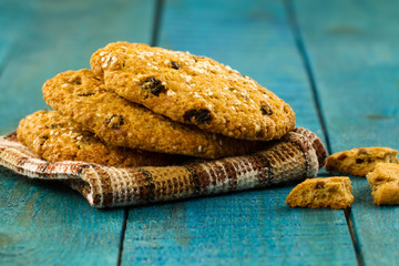 Chocolate chip cookies on an old vintage turquoise wooden background.
