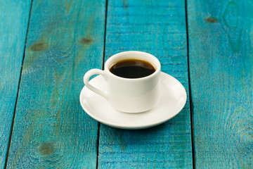 Set table for breakfast. Hot Cup of coffee on turquoise wooden background
