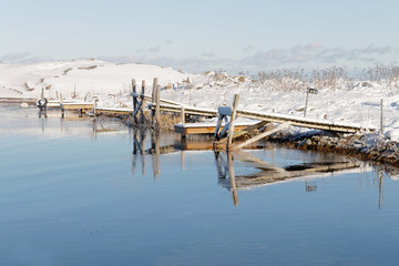 Small wodden bridges reflecting in the water in the wintry archi