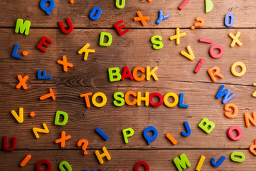 Colorful plastic letters, numbers, back to school,  wooden backg