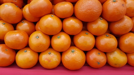 pile of fresh oranges for sele in market.