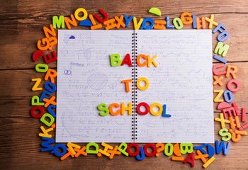 Colorful plastic letters, back to school, notebook with formulas