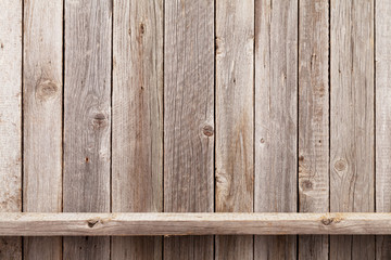 Wood shelf in front of wooden wall © Evgeny Karandaev