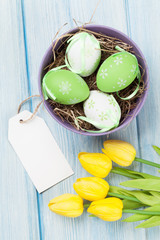 Easter with eggs and yellow tulips