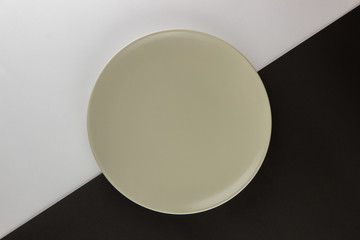 A number of flat plates and cups on black and white background