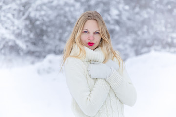 In winter morning young woman with red lips and white sweater