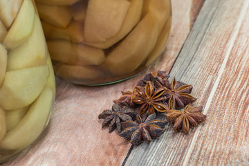Star Anise and Cloves on Wooden Background with Preserved Pear C