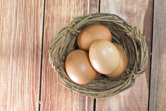 A Wicker Basket with three Eggs from the Top View