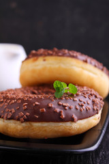 donuts with chocolate on a dark background