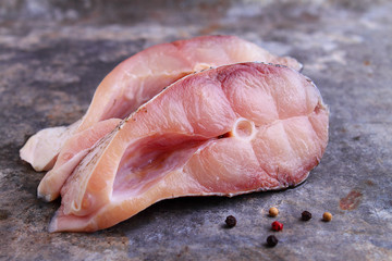 pieces of raw white fish on a metal background