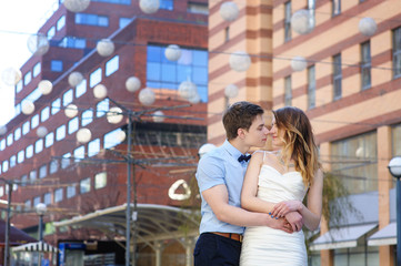 Bride and groom walking around among the houses and buildings