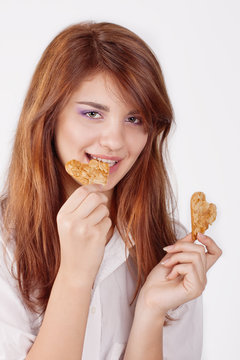 Portrait of young woman eating cookie