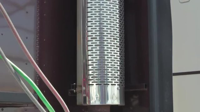 Slow pan up of exhaust tube from freight liner truck