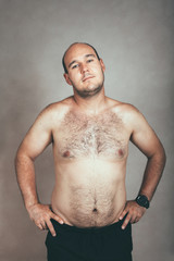 Corpulent hairy shirtless man