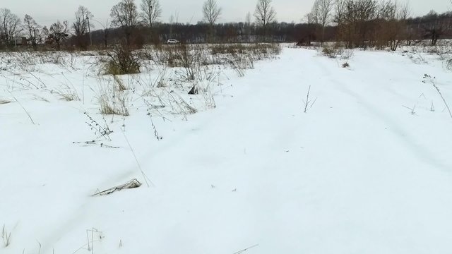 aerial view on a snowy field and road from quadrocopter