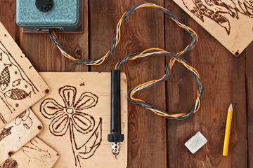 Pyrography workshop. A pyrography tool and a floral model. - 103037351