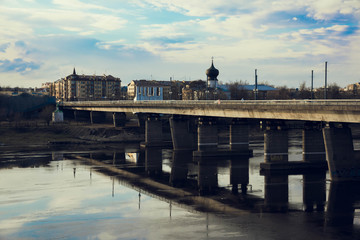 Fototapeta premium Pskov, bridge over the Velikaya river, mirroring sky