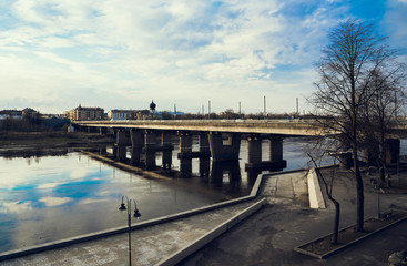 Fototapeta na wymiar Pskov, bridge over the Velikaya river, mirroring sky