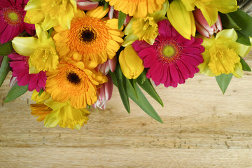 Fototapeta premium Multicolored bouquet spring flowers on wooden background