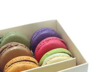 Tasty colorful macaroon in box paper on white background