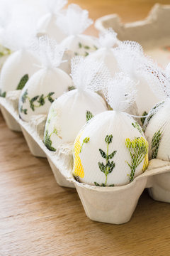 Eggs wrapped with herbs and flowers before painting in order to have patterns on colored eggs